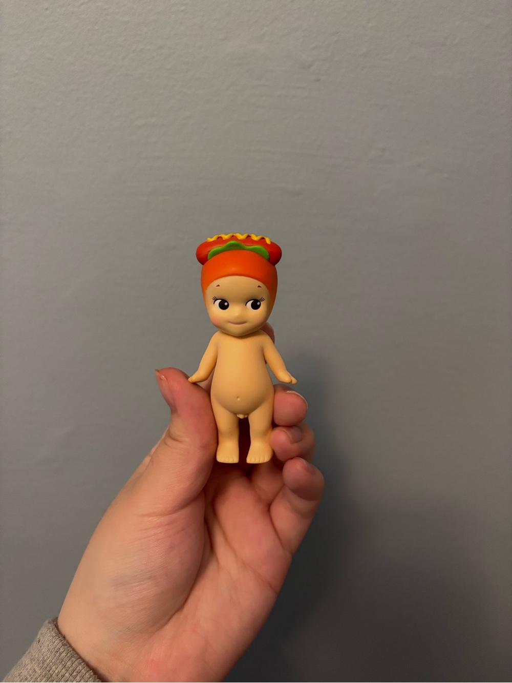 Cute Baby Doll Figurine with Orange Hot Dog Hat